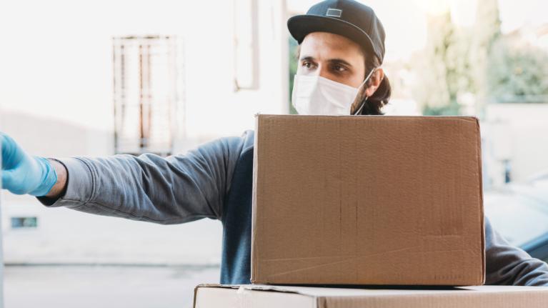 young delivery man delivering packages