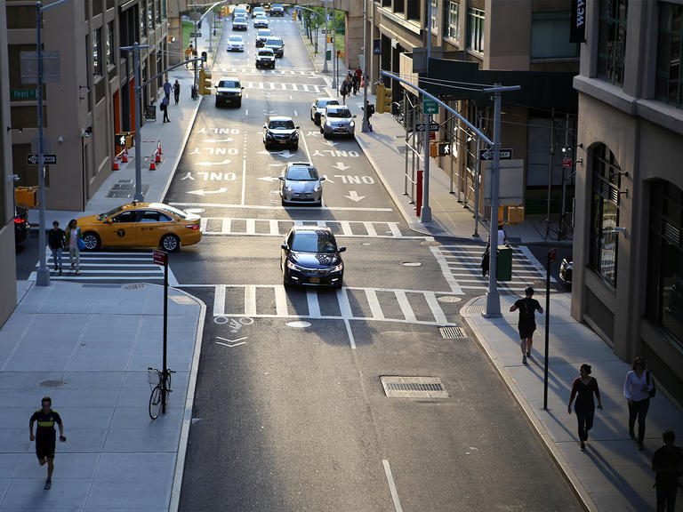 A car travels through an intersection in an American city.
