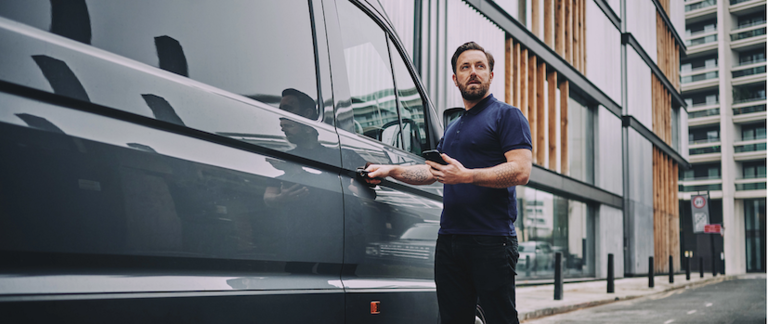 A delivery driver about to get into his van.